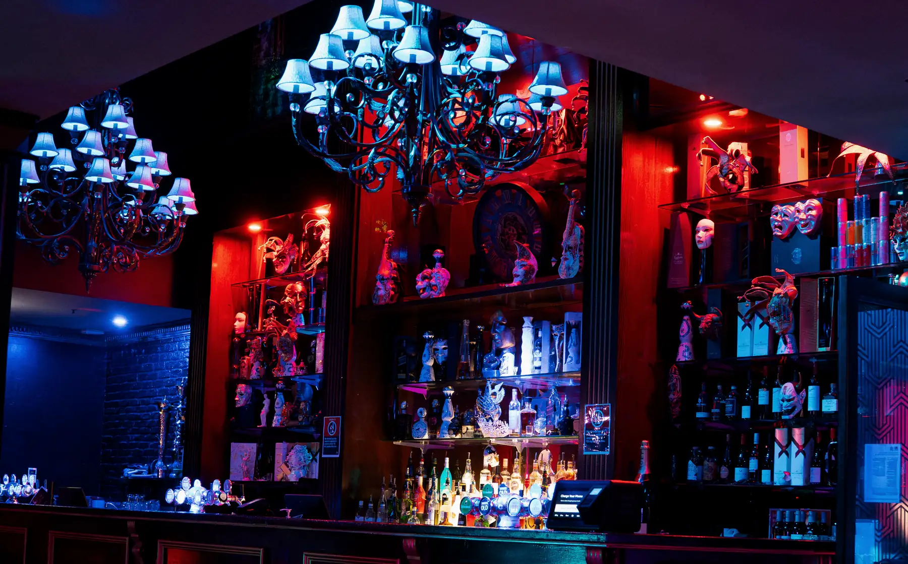 The long downstairs main bar under its chandeliers