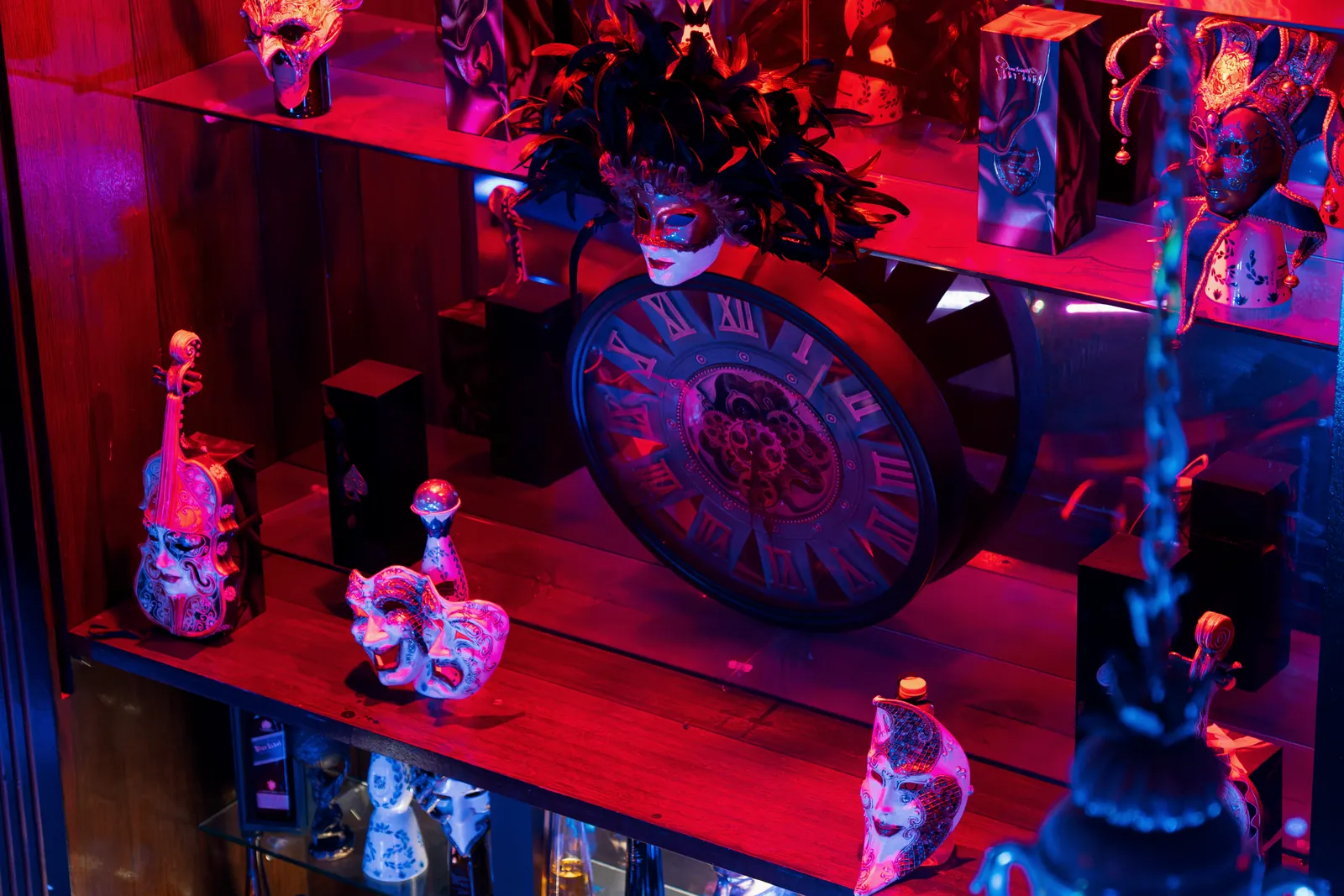 Venetian masks and a gear clock on the bar shelves