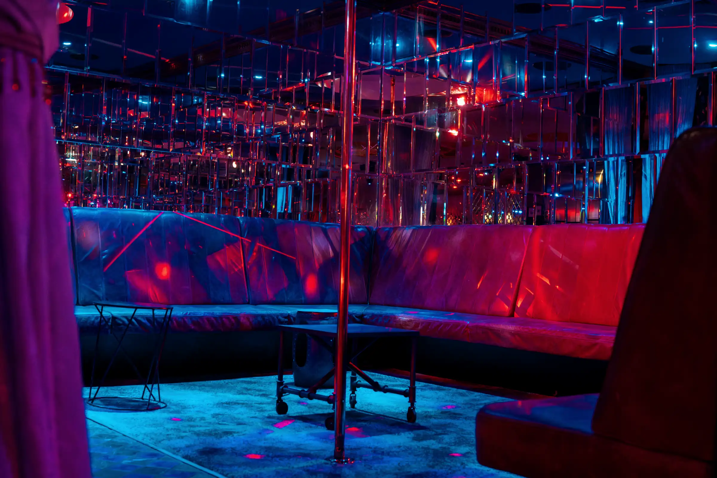 Blue leather banquettes and mirrored walls in the downstairs booth room