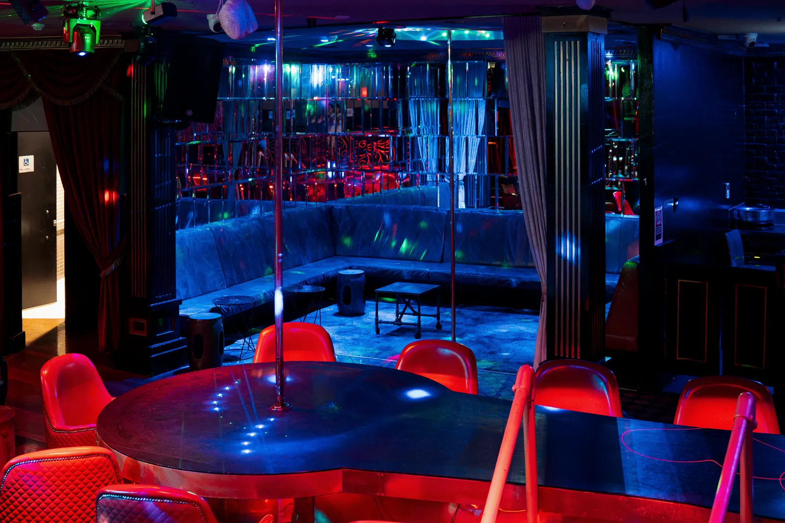 Blue banquettes in the mirrored booth room